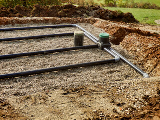 The top layer of pipework, after the membrane, sand and gravel had been applied, during the...