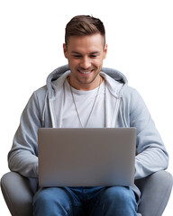 young man in a grey hoodie sits and smiles as he uses a laptop isolated on transparent background