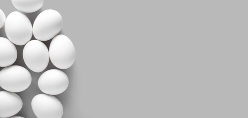 Raw chicken eggs on grey background with space for text