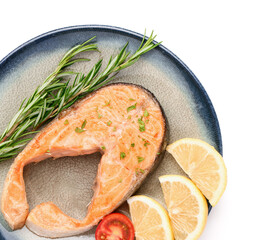 Plate of tasty fried salmon steak with lemon on white background