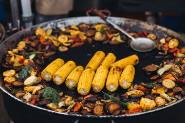 Food festival with food stall kiosk, open-air outdoor fair market, assortment of different traditional European grilled barbecued street food with sausages, bbq, chicken, pork and lamb on a large pan