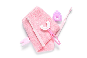 Towel with children's toothbrushes and dental floss on white background