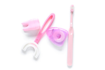 Children's toothbrushes with dental floss on white background