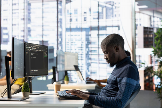Computer technician doing software quality assurance, reading source code on computer before implementing it. IT admin inspecting coding on PC device, looking to fix potential issues