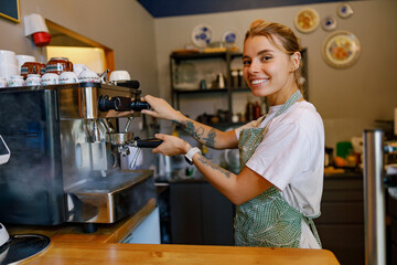 A friendly, smiling barista skillfully preparing a delicious espresso in a warm, cozy coffee shop...