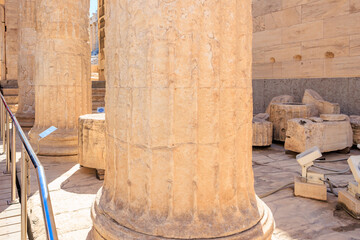 The pillars are made of stone and are very tall, the Acropolis of Athens