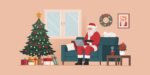 Contemporary Santa Claus connecting with his laptop