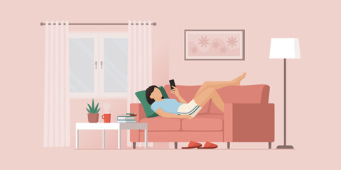 Girl relaxing on the couch and social networking on her smartphone