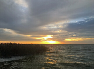 Autumn sunrise over the Curonian Lagoon. View of the bay from the resort town of Nida, Lithuania.