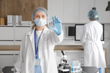 Female scientist with Petri dish in laboratory