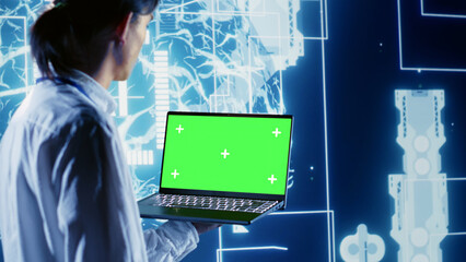 Precise admin using green screen laptop to write artificial intelligence script code in startup workplace. Skillful professional doing maintenance work in data center, updating AI systems