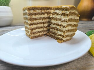 a piece of honey cake on a white plate. High quality photo