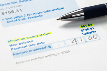 Credit card statement bill showing paying the minimum payment amount