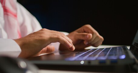 Close up shot of businessman using laptop in office to send emails. Worker typing on notebook keyboard, composing documents in order to deliver finalized project paperwork to management
