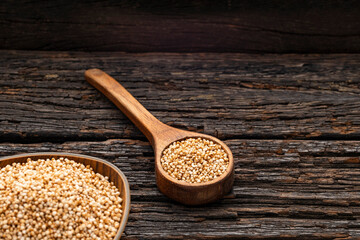 Organic amaranth seeds in the bowl and spoon - Amaranthus. wooden background