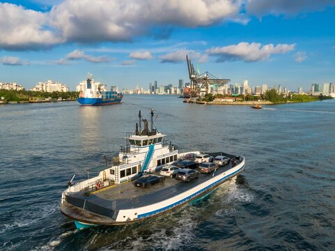 The Fisher Island Car Ferry in the Biscayne Bay. In the background is the South Florida Container Terminal, Miami, Florida, United States.