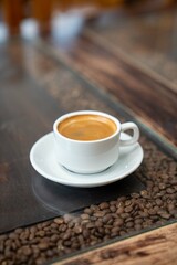 vertical shot of black espresso on top of coffee table during the morning