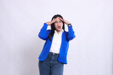 expression of beautiful mature office woman wearing blue formal suit standing candid screaming...