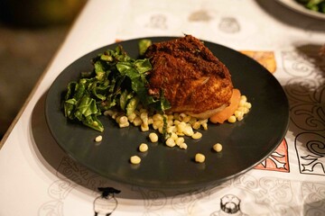 delicious entree of fish with corn and salad on the side at south american restaurant for dinner