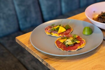 colorful tortilla covered with ahi tuna avocado mango cilantro and lime at a fine dining mexican restaurant