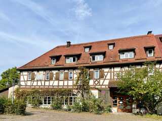 Charming traditional German style house with red roof and green plants