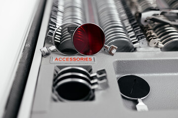 A vision measuring instrument with a trial frame used by optometrists for vision testing and...