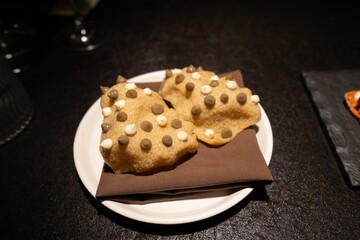 brown puff with various sauces dotted along appetizer at beautiful restaurant