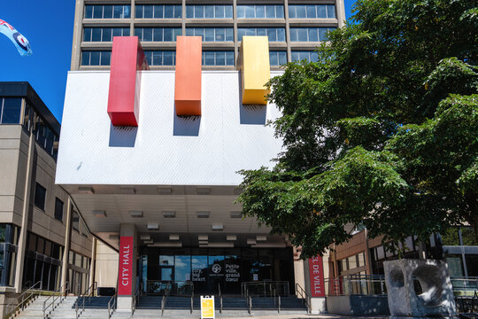 St John, NB, Canada - Sept. 11, 2024: Saint John City Hall includes a design of three aluminum columns painted red, orange, and yellow at the exterior entrance by Canadian sculptor Claude Roussel.