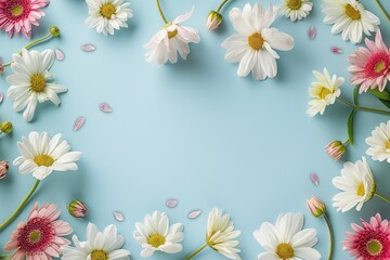 Obraz premium Beautiful frame made from colorful flowers on blue background. Various types of flowers bloom in festive flat design. Frame is perfect for celebrating birthdays, holidays, and special occasions.