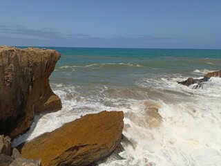 Wild Sea Waves Breaking Against Natural Stone Formations