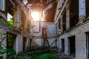 Ruined mansion hall interior overgrown by plants. Nature and abandoned architecture, green post-apocalyptic concept