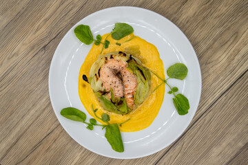 Overhead view of Salmon cooked to perfection served with squash and cabbage