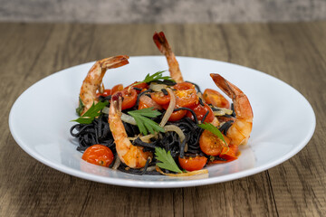 Medium sized shrimp served over tagliolini pasta with cherry tomato