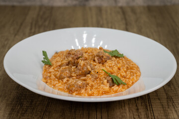 Italian risotto served with sausage and tomato sauce over a bed of rice