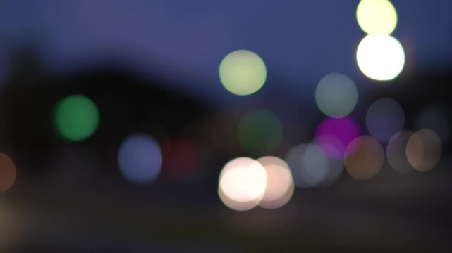 Night street lights blur bokeh of cars in traffic on the road at night. Blurred abstract bright colored bokeh. Bokeh lights on city night background.