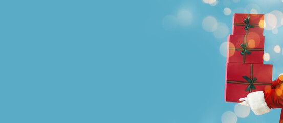 Santa Claus with Christmas presents on blue background