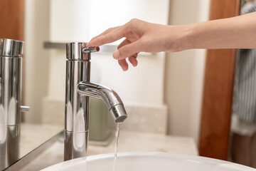 Save water. Volunteer keeps turning off the running water in the bathroom to protect environment....