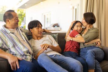 Relaxing on couch, happy family bonding and spending quality time together