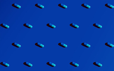 Blue pills on a clean blue background