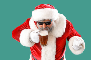 Bad Santa Claus drinking beer on green background