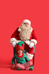 Santa Claus and cute little elf on red background