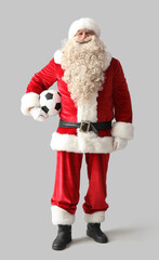 Santa Claus with soccer ball on white background
