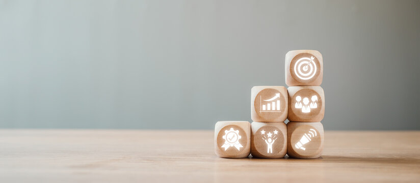 Wooden blocks with icons representing unique selling propositions on a wooden table, ideal for business and marketing concepts.