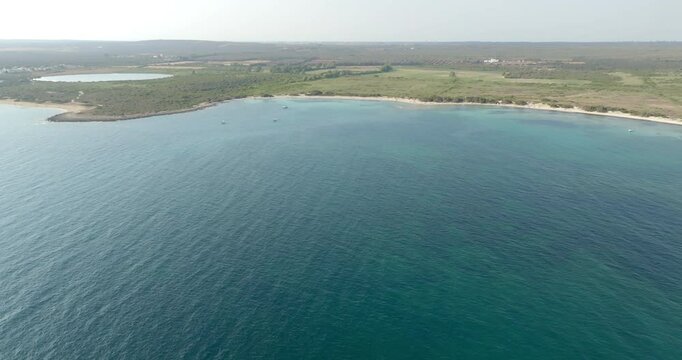 Aerial view of Palude del Conte beach,near Porto Cesareo, in the province of Lecce, in Salento, Italy. It is a sandy beach with a nature reserve. On the horizon there is the Torre Colimena basin.