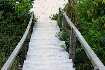 Photo of wooden stairs descending to the sand.