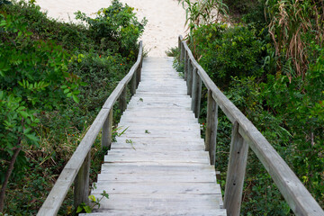 Photo of wooden stairs descending to the sand.