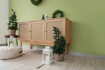 Interior of living room with Christmas trees and commode