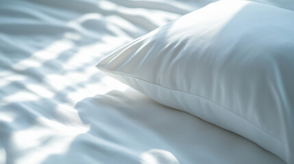 Obraz premium a close-up of a soft white pillow on smooth white sheets, where the play of light and shadow creates a dynamic yet calming composition