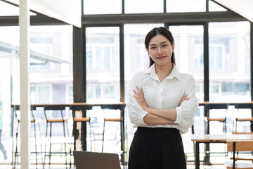 Young Female Accountant Working on Laptop in Modern Office with Bright Natural Light and Contemporary Interior Design