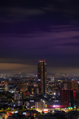 Mexico City Night Skyline at Moon Rise in Ciudad de México: Beautiful vibrant historic metropolis and one of the most populous cities in North America at an altitude of 7,350 ft.
